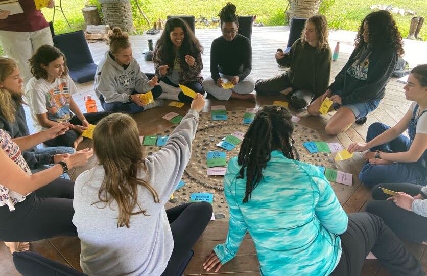 Diverse circle of students gather for activities.